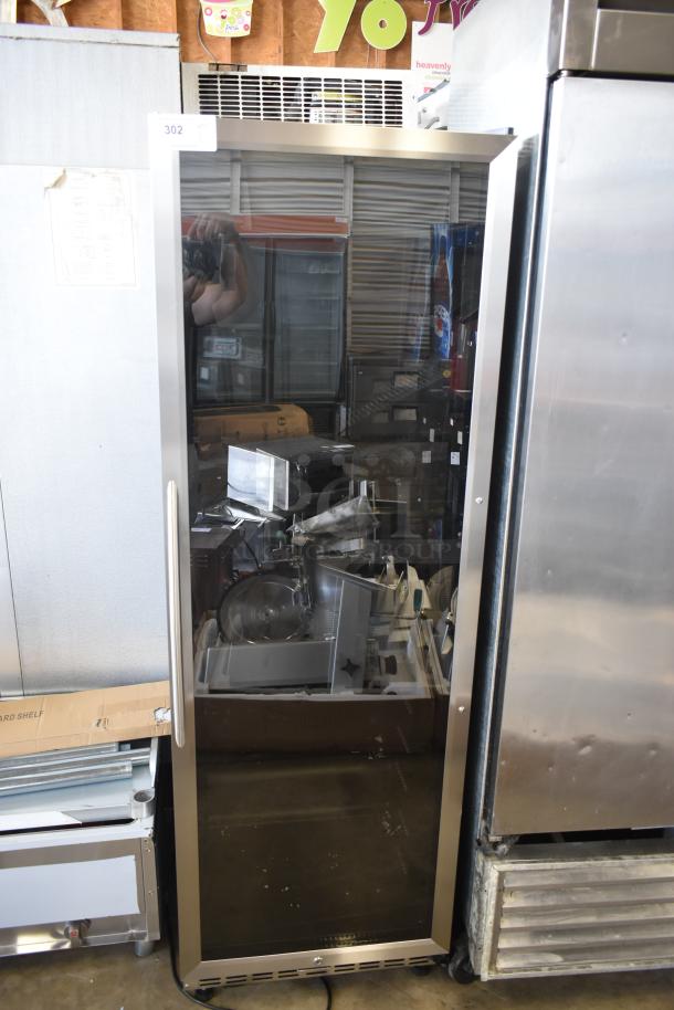 Commercial glass door refrigerator with stainless steel frame. Visible inspection tag number 302. Used condition.