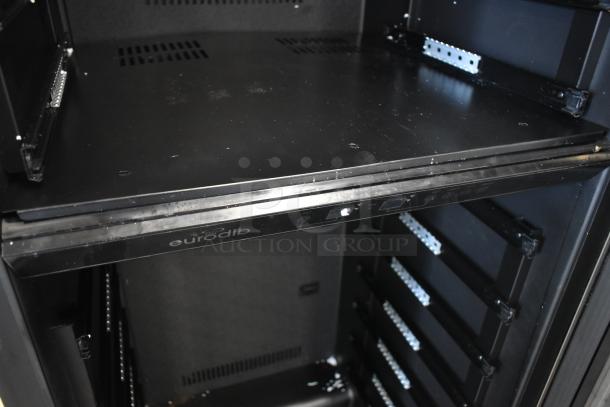 Eurodib commercial refrigerator interior, black, with adjustable metal shelves. Slight wear visible. Model details not shown.