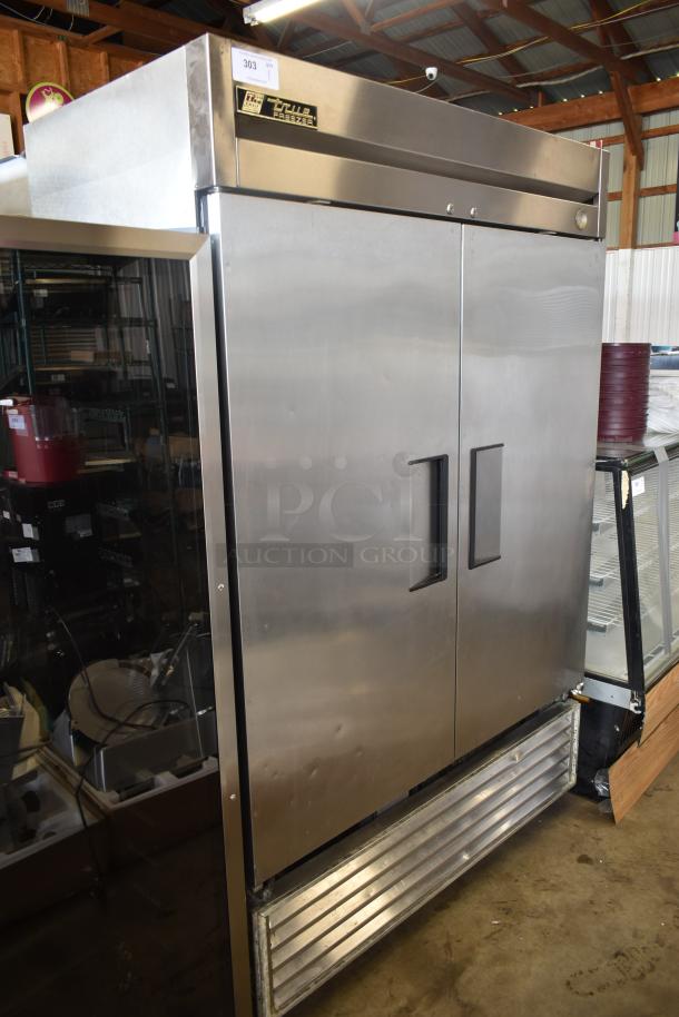 True freezer, stainless steel, double door, commercial grade, model T-49F. Good condition with some surface wear.