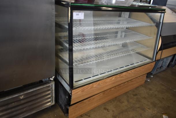 Glass display case with three metal shelves, wood trim base, and auction tag reading "305". Used condition.