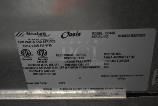 Label on Structural Concepts Oasis cooler, model CO44R, showing electrical specs, refrigerant data, service contact info.