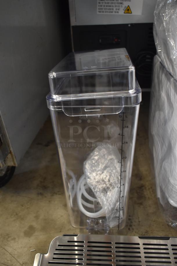 Clear plastic container with lid, measuring scale in liters, includes tubing and a plastic bag inside. Appears unused.