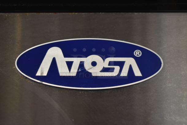 Oval Atosa logo badge on stainless steel surface, indicating brand authenticity. Slight wear visible, enhancing industrial appeal.