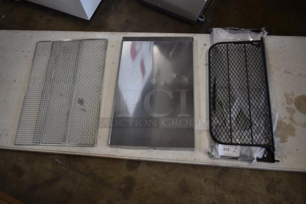 Metal wire mesh trays and a reflective metal sheet displayed on a table. Items appear in good condition; tag number 312 visible.