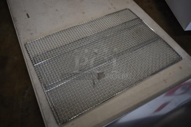Metal wire mesh panel, rectangular, in used condition, with slight discoloration. Ideal for industrial or home projects.