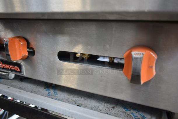 Commercial stainless steel stove with orange control knobs, "ON" and "OFF" marked. Brand label: Sierra. Good condition.