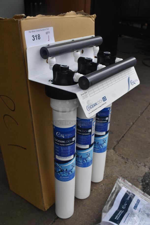 Ocean Loch L3 water filtration system, new condition, with installation and service labels visible, boxed for auction.
