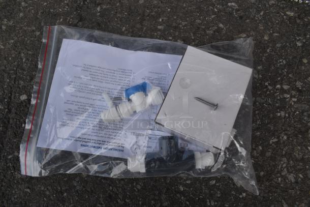Plastic plumbing fittings in sealed bag with installation instructions, screw, and connector parts. New condition.