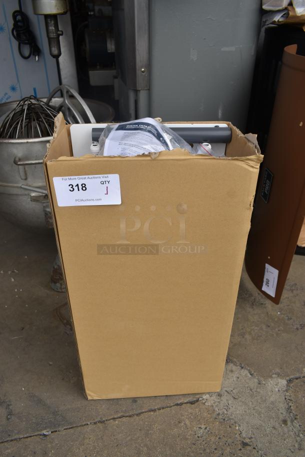 Cardboard box with auction label "318" containing a Holmes heater. Includes installation manual and components. Appears new.