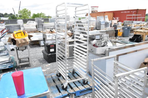 Metal bakery rack on wheels with multiple shelves, used condition, suitable for commercial kitchens.