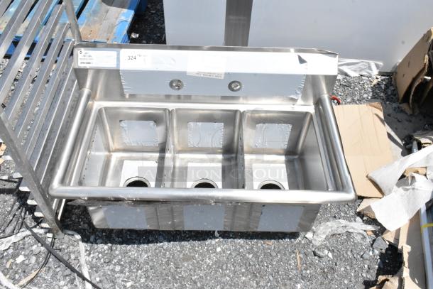 Triple-compartment stainless steel sink, new, with protective film. Includes pre-drilled faucet openings and drainage holes.