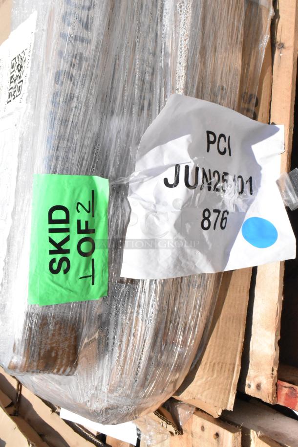 Pallet wrapped in plastic, labeled "Skid 1 of 2" with markings "PCI JUN25D1 876" indicating shipping details.