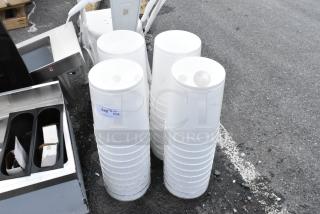 Stacks of white plastic buckets with lids, possibly used for storage or transportation. Visible label reads "328, Qty x40".