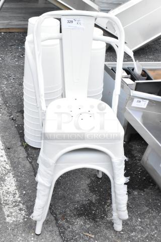 White metal stacking chair with a perforated seat and wrapped legs. Tag notes "329," indicating auction lot number.
