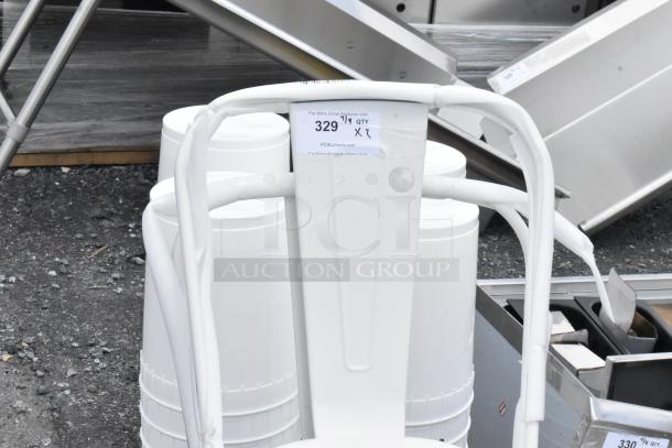 White metal chair with curved backrest, shows signs of wear. Attached tag indicates auction item number 329.