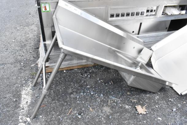 Stainless steel commercial chute with angled design and sturdy legs. Visible labels indicate model 319. Excellent condition.
