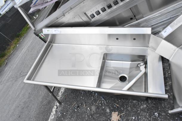 Stainless steel commercial sink, single basin, with integrated drainboard. Appears in excellent condition. Tags: lot 319.