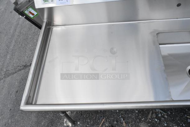 Stainless steel prep table with sink, excellent condition, NSF certified, Regency brand label visible.