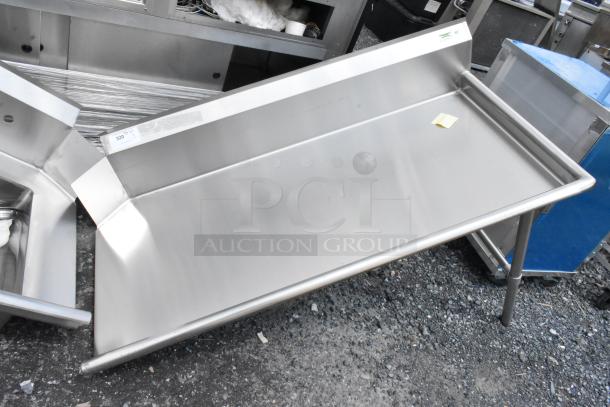 Stainless steel prep table with raised edges, excellent condition, features a rear backsplash, and sturdy legs.