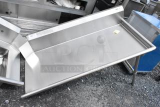 Stainless steel prep table with raised edges, excellent condition, features a rear backsplash, and sturdy legs.