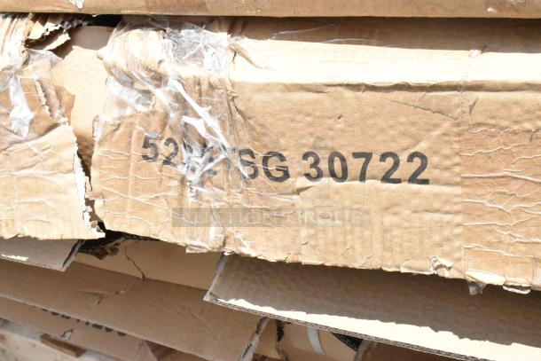 Close-up of a corrugated cardboard box with visible wear and tear. Markings read "5276G 30722" in black ink.