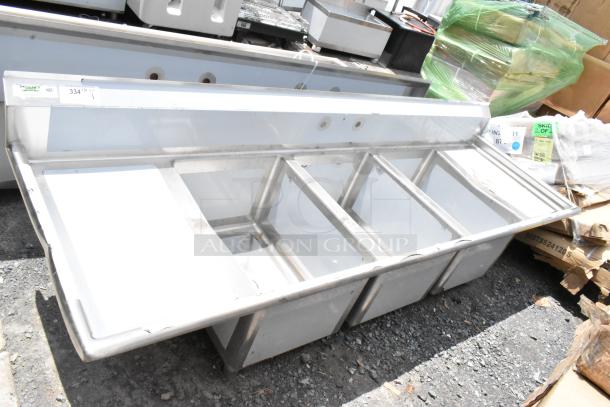 Stainless steel multi-compartment commercial sink with NSF certification, features five deep basins, in good condition.