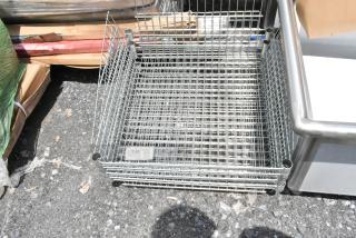 Metal wire basket stack, used condition, stacking design with tubular corners, labeled "338," suitable for storage.