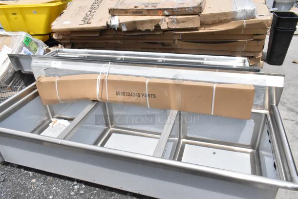 Stainless steel multi-compartment sink, new, Regency brand, with parts labeled "600S32424S PARTS."