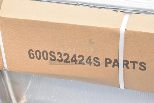 Brown cardboard box labeled "600S32424S PARTS," featuring white strapping for secure closure.