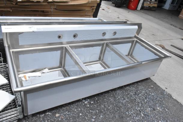 Commercial stainless steel sink with three compartments, used condition, Regency brand label, slight wear and surface marks.
