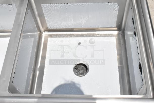 Stainless steel sink basin in excellent condition, features drainage hole centered, reflective surfaces, no visible markings.