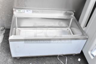 Stainless steel commercial cooler by Regency, model 340. Features a deep basin and NSF certification. Shows signs of use.