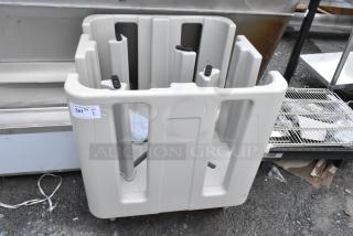 Gray plastic dish rack with multiple slots, on wheels, in used condition. Label reads "341 1 QTY 1" for auction.