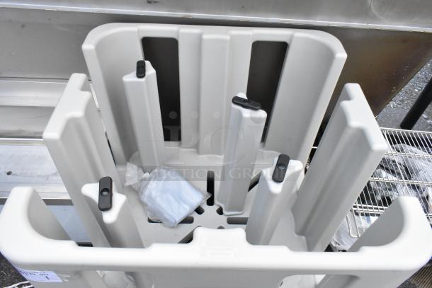 Gray cart with multiple vertical slots and attached plastic bag, designed for storage or transport, in good condition.