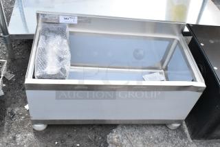 Stainless steel commercial ice bin with label showing auction lot number. Includes bubble-wrapped accessory. Good condition.