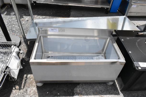 Stainless steel insulated ice bin with enclosed design. Visible label indicates item number. Good condition, suitable for bars.