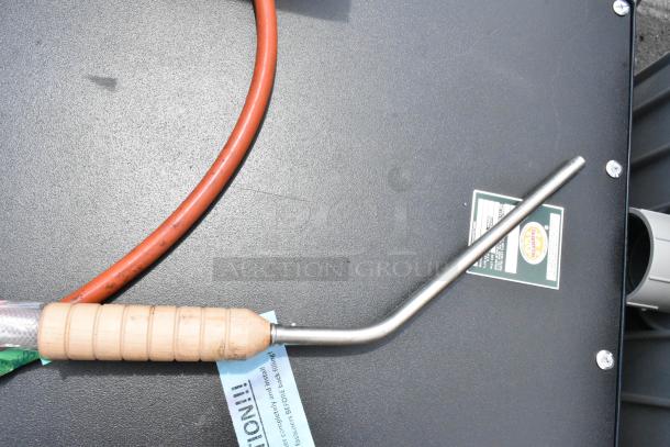 Wood-handled metal probe with orange cable, attached to a machine. Labels indicate brand and usage instructions. Excellent condition.