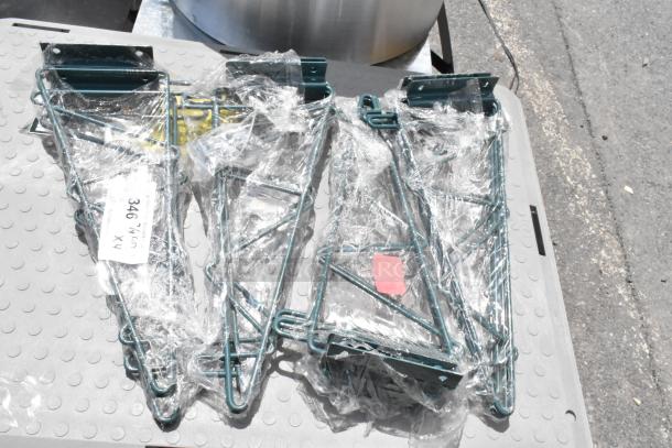 Set of four green metal wall brackets in plastic wrap, labeled "346 x4." New condition, sturdy design.