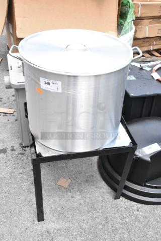 Large stainless steel stockpot with lid on a black metal stand. Label indicates 348 1/4 QT. Appears in good condition.