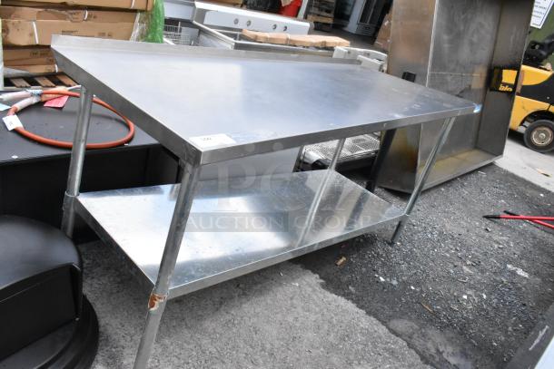 Stainless steel worktable with shelf, good condition, minor scuffs, ideal for kitchen use. Label reads "300."