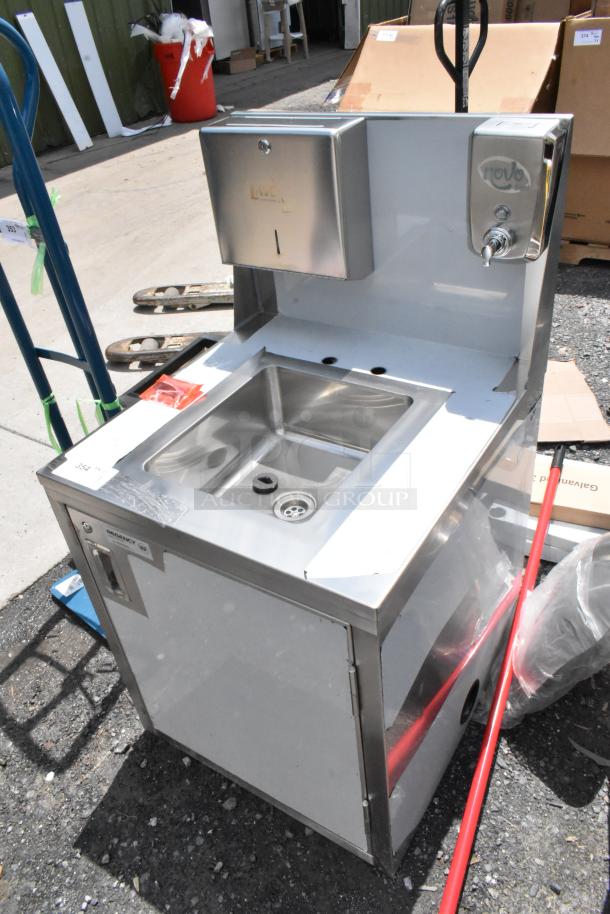 Commercial stainless steel handwashing station with automatic faucet, soap dispenser, and integrated paper towel holder. Good condition.