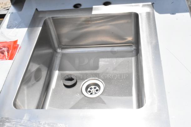 Stainless steel sink, single basin, with no visible markings. Includes drain cover. Appears in good condition.