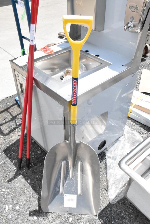 Westward snow shovel with yellow handle and stainless steel blade, new condition. Features manufacturer label and barcode.