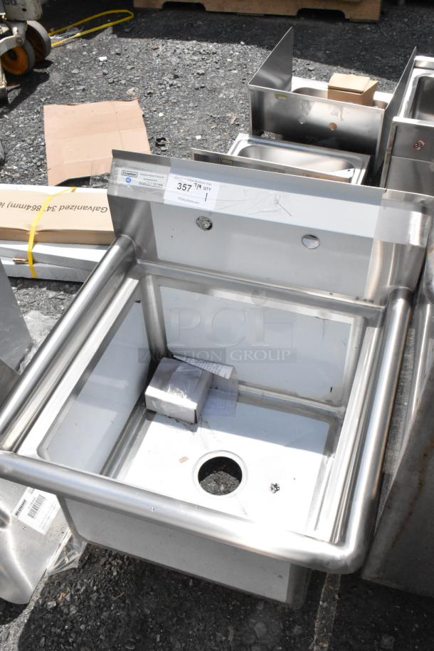 Stainless steel commercial sink, new condition, with drain hole. Label indicates model info and auction site details.