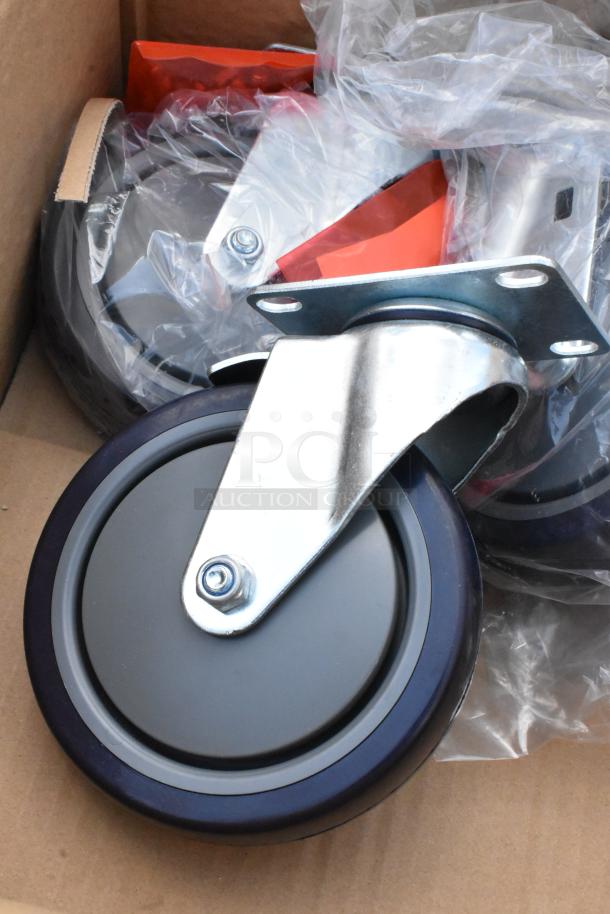 Heavy-duty caster wheels with metal swivel plates, new in packaging, durable rubber construction for industrial use.