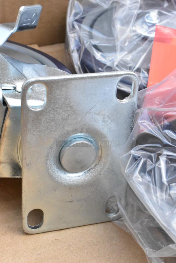 Heavy-duty metal caster wheel, new in packaging, with mounting plate and swivel mechanism visible.