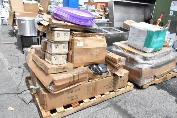Pallet of mixed items including cardboard boxes, plastic tubs, and appliances, some marked "600WS1234." Various conditions.