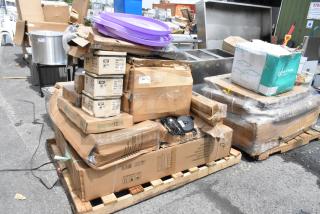 Pallet of mixed items including cardboard boxes, plastic tubs, and appliances, some marked "600WS1234." Various conditions.