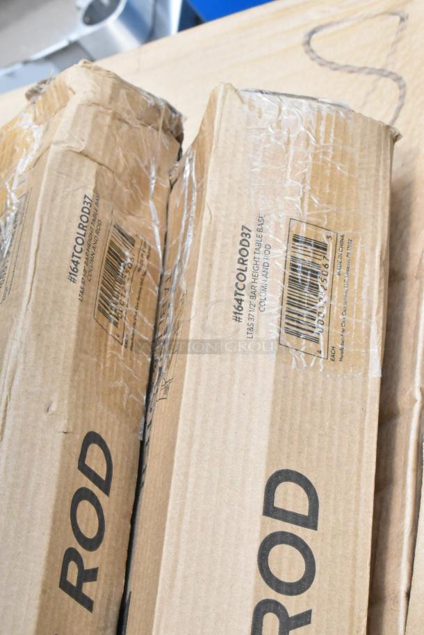 Two cardboard boxes labeled "ROD" containing bar height table base columns and rods. Boxes appear sealed and intact.