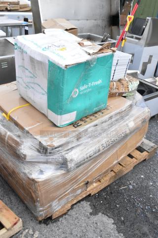 Pallet with shrink-wrapped cardboard boxes and a Safe-T-Fresh container, showing wear. Suitable for bulk buyers.